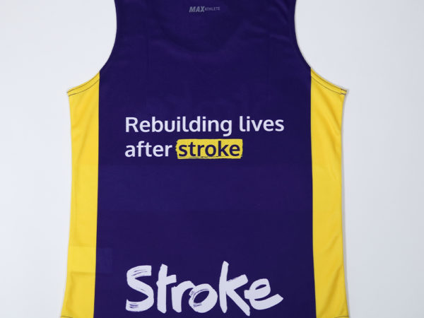 Purple and yellow running vest. Text on it reads: "Rebuilding lives after stroke. Stroke Association"